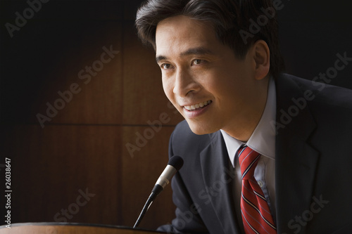 Photo: Chinese businessman speaking at podium Chinese businessman speaking at podium