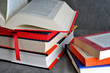 A pile of colorful books on a gray background