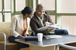 African couple looking at book together