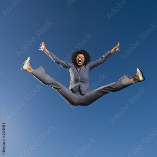 Photo: African businesswoman jumping in mid-air African businesswoman jumping in mid-air