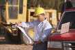 Hispanic male contractor looking at blueprints