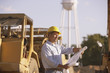 Hispanic male contractor looking at blueprints