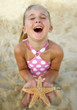 High angle view of girl holding starfish at beach