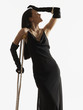 Pacific Islander woman in evening gown leaning on crutch