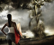 African woman holding kite and looking at tornado