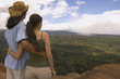 Couple hugging and looking out over landscape