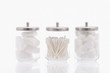 Studio shot of jars with cotton balls and swabs