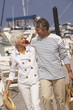 Senior couple strolling at marina