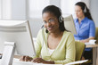 African businesswoman with headset at desk