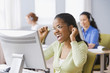 African businesswoman cheering at desk