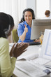 Businesswomen with headsets celebrating at desk