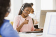African businesswoman with headset giving thumbs up