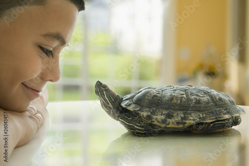 Photo: Close up of Hispanic boy smiling at turtle Close up of Hispanic boy smiling at turtle