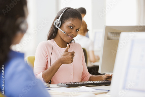 Photo: African businesswoman with headset giving thumbs up African businesswoman with headset giving thumbs up