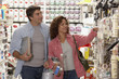 Hispanic couple shopping for painting supplies
