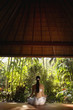 Pacific Islander woman meditating in jungle