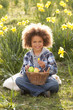Boy On Easter Egg Hunt In Daffodil Field Boy On Easter Egg Hunt In Daffodil Field