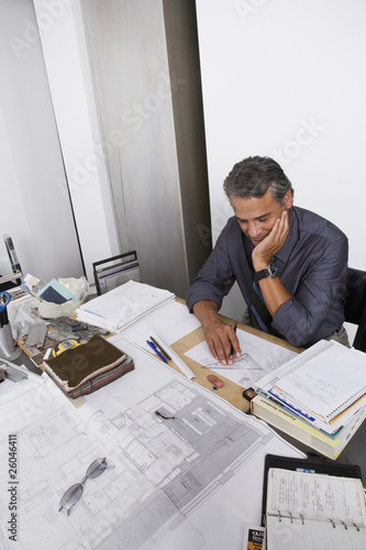 Photo: Hispanic architect working at desk Hispanic architect working at desk