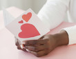 African woman holding ValentineÕs Day card