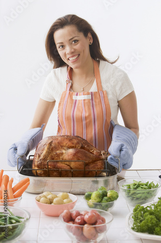 Photo: Hispanic woman preparing Thanksgiving dinner Hispanic woman preparing Thanksgiving dinner
