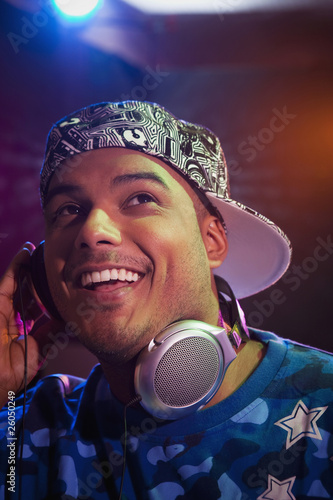 Photo: Hispanic dj listening to headphones Hispanic dj listening to headphones