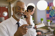 African business owner checking credit card over the telephone
