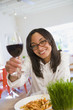 Mixed race woman enjoying wind in cafe