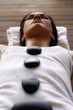 Pacific Islander woman having hot stone massage