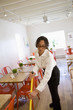Mixed race woman mopping floor in cafe