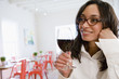 Mixed race woman enjoying wind in cafe