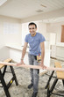 Hispanic man using sawhorse in kitchen