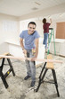 Hispanic man using sawhorse in kitchen