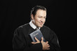 Hispanic pastor holding Bible