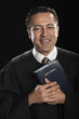 Hispanic pastor holding Bible