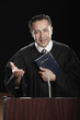 Hispanic pastor holding Bible at podium