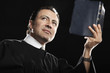 Hispanic pastor holding up Bible