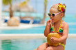 portrait of cute toddler girl with coconut