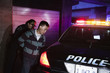 Policewoman handcuffing man