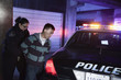 Policewoman handcuffing man