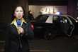 Mixed race news reporter reporting at crime scene