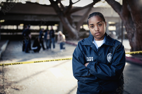 Photo: African policewoman standing outside crime scene African policewoman standing outside crime scene