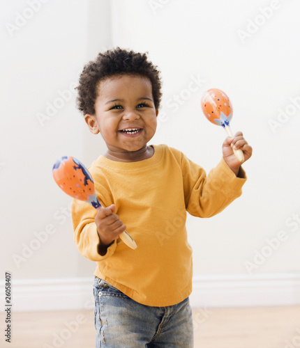 Photo: African toddler playing with maracas African toddler playing with maracas