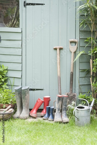 Photo: Gardening tools at door of potting shed Gardening tools at door of potting shed