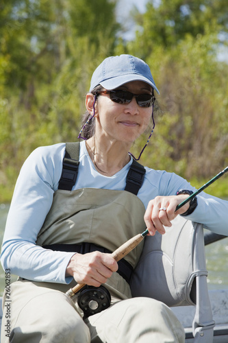 Photo: Japanese American woman holding fly fishing pole Japanese American woman holding fly fishing pole