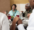 Family saying grace at dinner table
