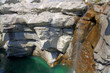 rocky canyon filled with green water