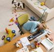 Hispanic woman sleeping at desk surrounded by toys
