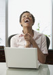 African woman with laptop laughing