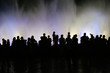 Silhouettes of people in front of the fountain Silhouettes of people in front of the fountain