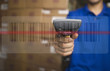 Hispanic man scanning barcode in warehouse